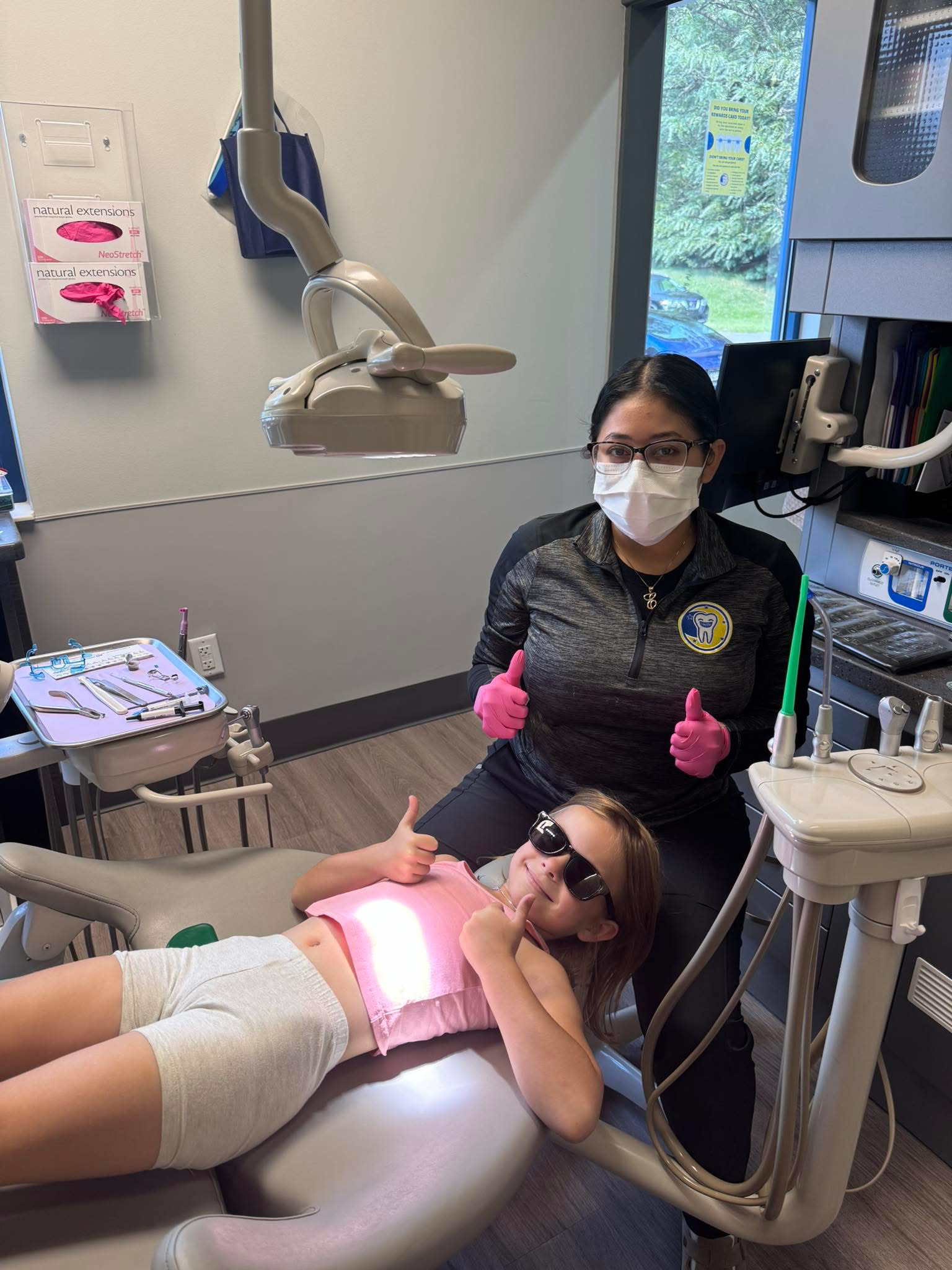 Happy young patient giving thumbs up after orthodontic visit at Stellar Orthodontics